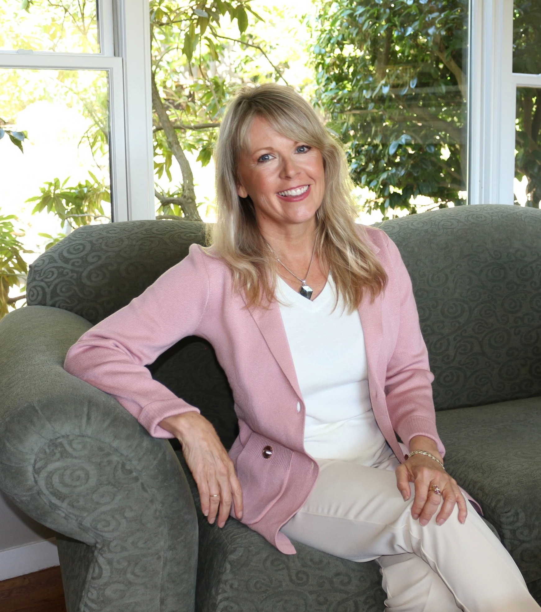 Tiffany Joy Basse, smiling, seated in a sunlit room